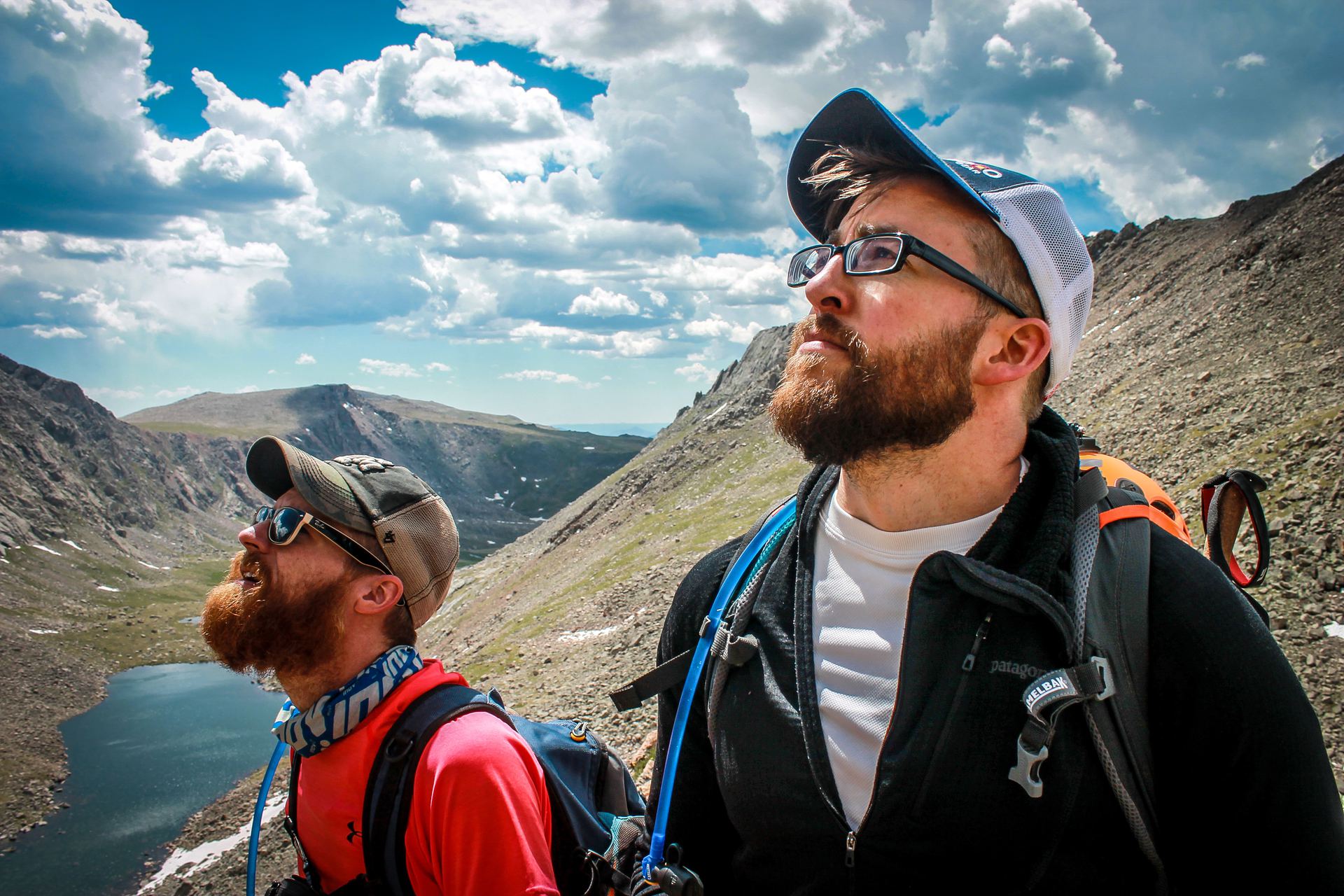 two male hikers looking up at the sky